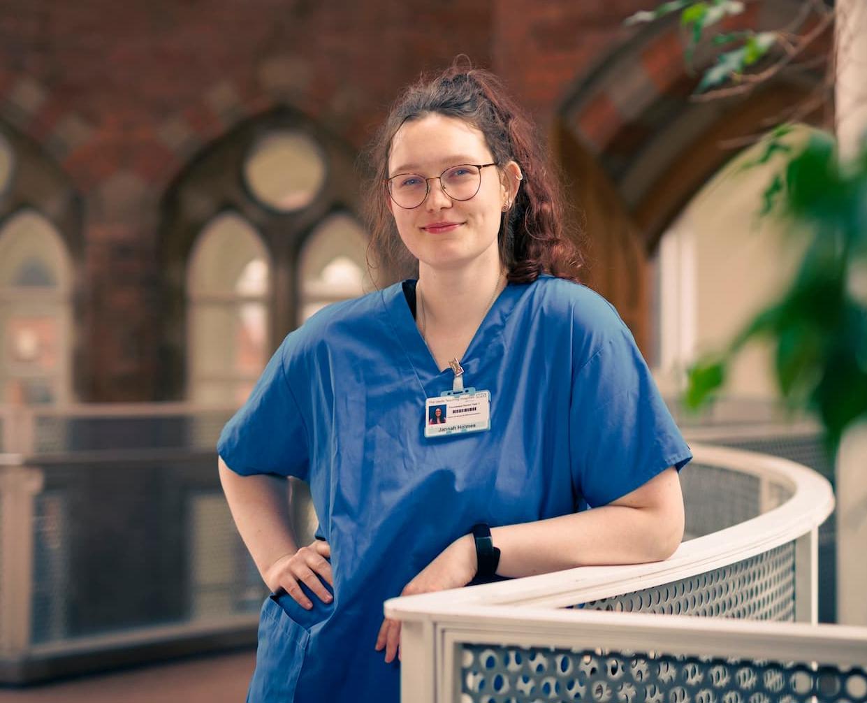 Jannah Holmes in blue scrubs