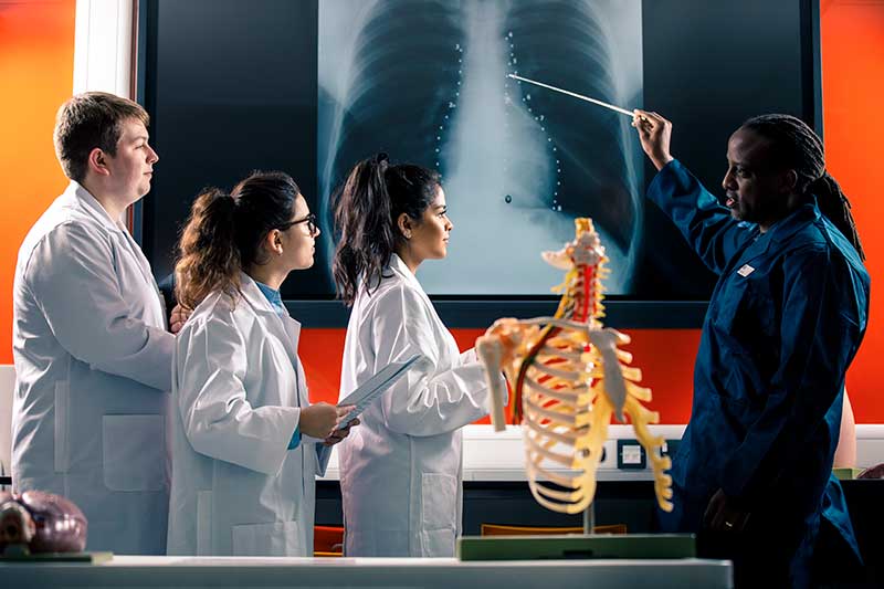 Students discussing a chest X-ray with Professor Peter Bazira