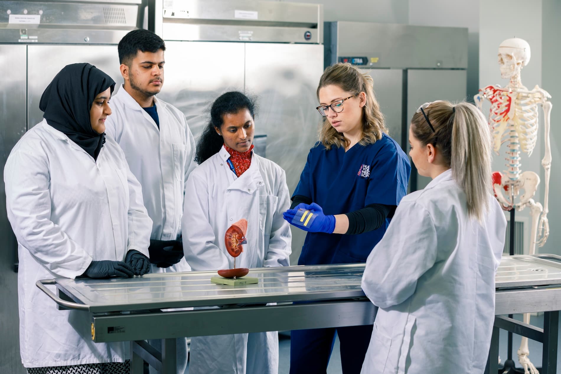 Students in the anatomy lab with Lauren Clunie inspecting prosections