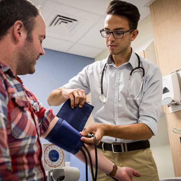 Medical student practising taking blood pressure