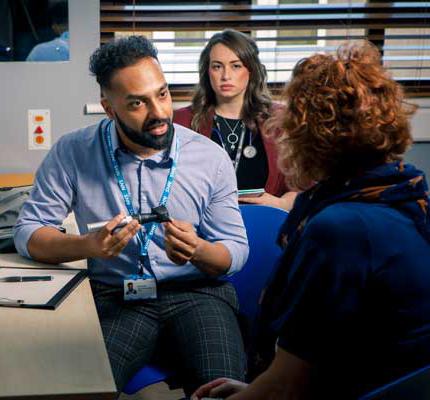 Medical student with patient a GP surgery, being supervised by a GP