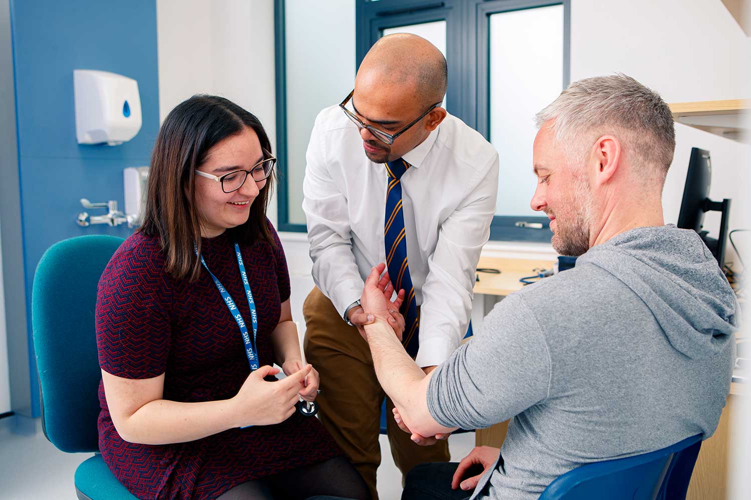 A Medicine student on a clinical placement at Brough Surgery examining a patient with their GP supervisor