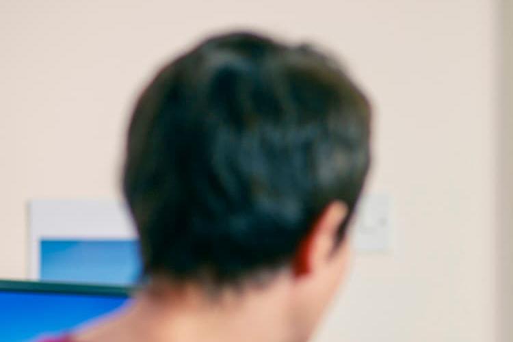 A GP talking to a patient in a consultation room