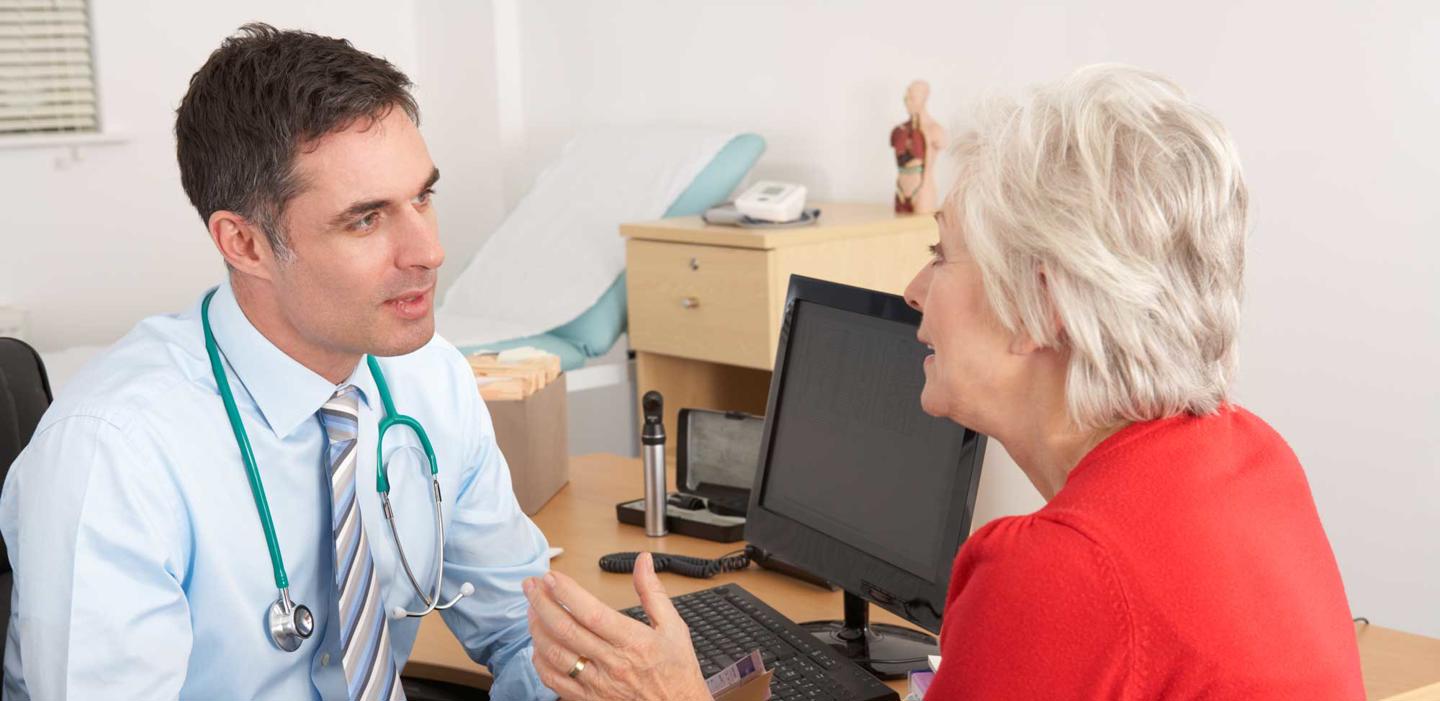 GP talking to a senior woman in the surgery