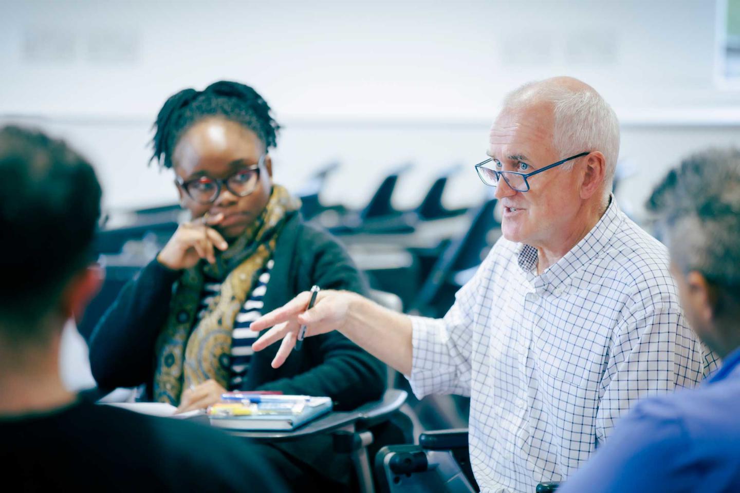 Health Professions Education tutor and students in discussion