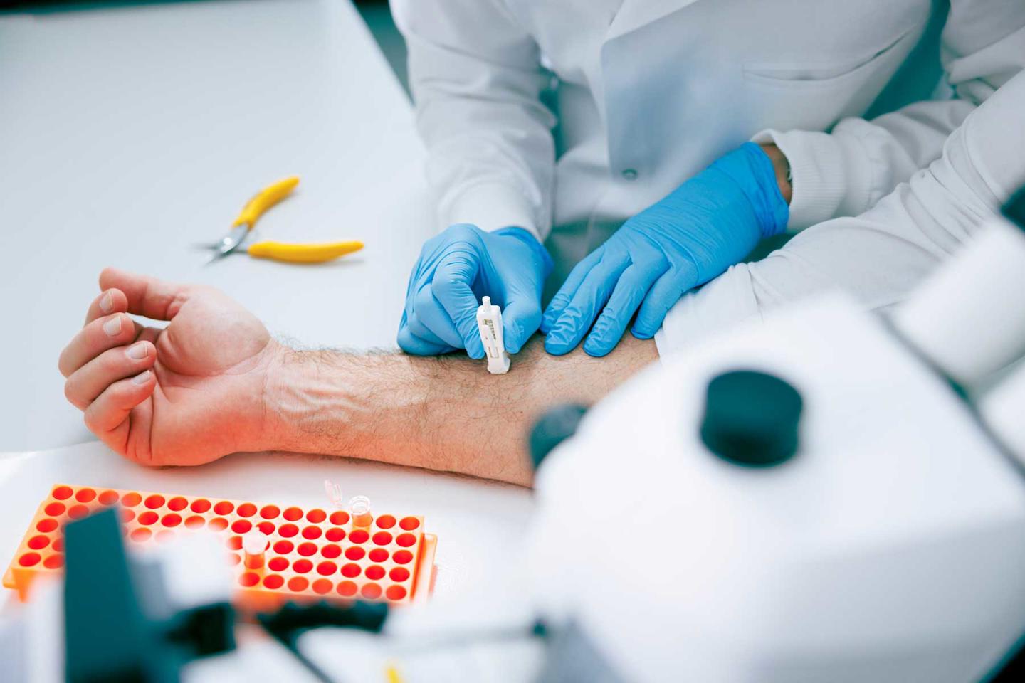 Skin microsampling device in use on a person's arm