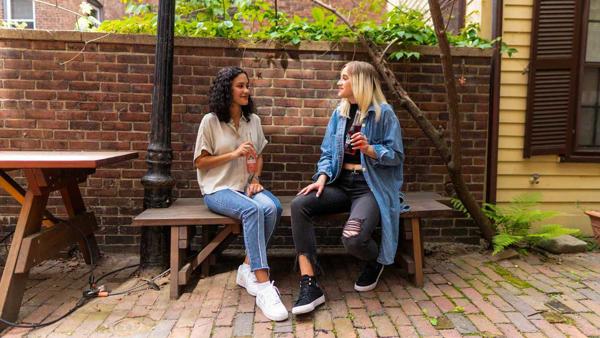 Two teens drinking soda