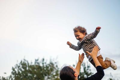 Mum throws a child into the air