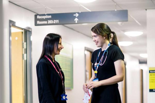 Two staff members in a GP surgery in discussion