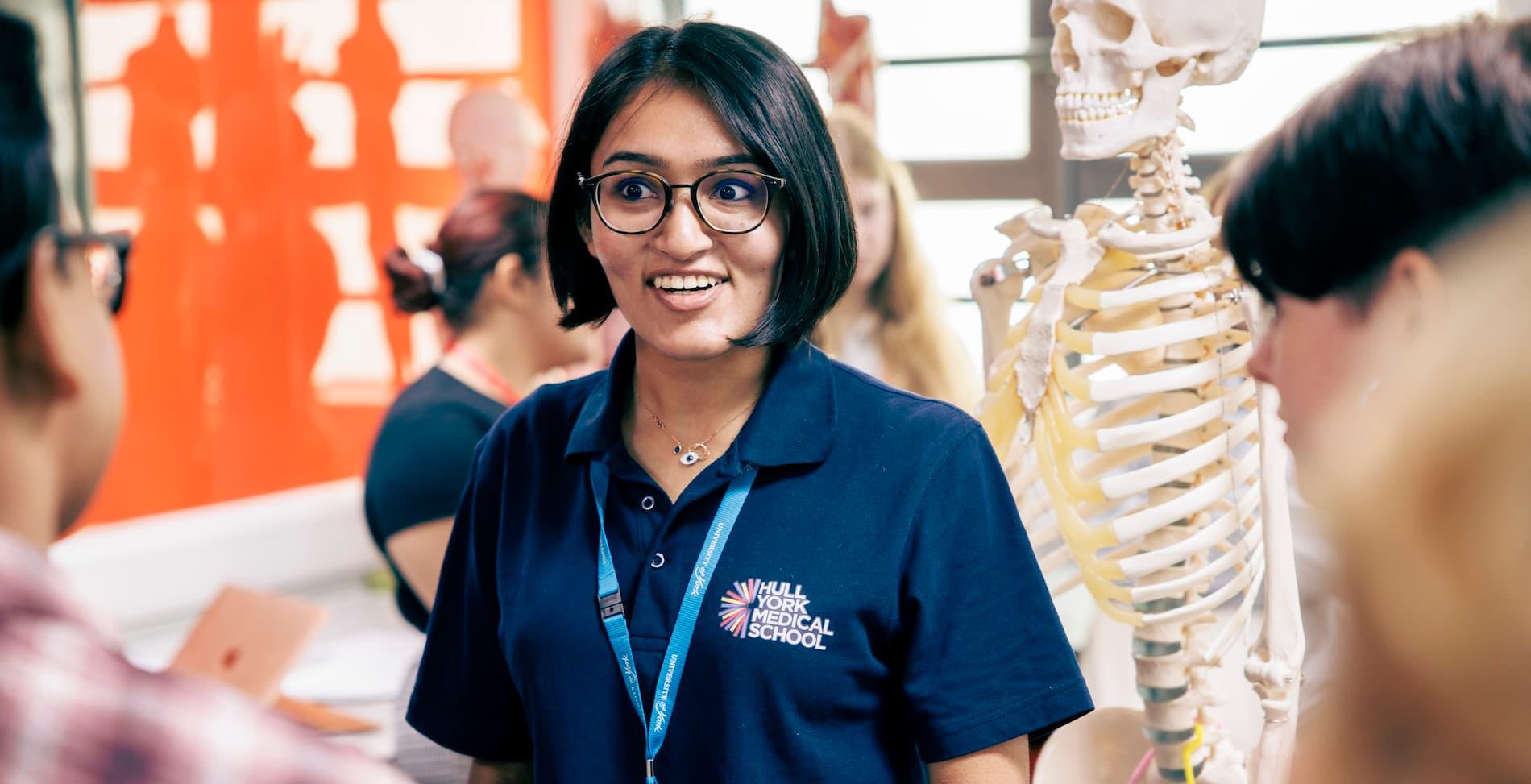 A member of Hull York Medical School staff chatting to students during an anatomy session